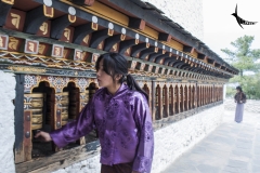 A young devotee rotating the prayer wheel at Changankha Lhakhang