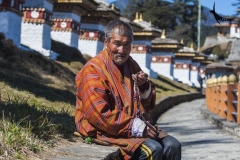 An elderly man chanting hymns