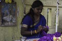 A lovely lady weaving a beautiful garland outside the Basilica